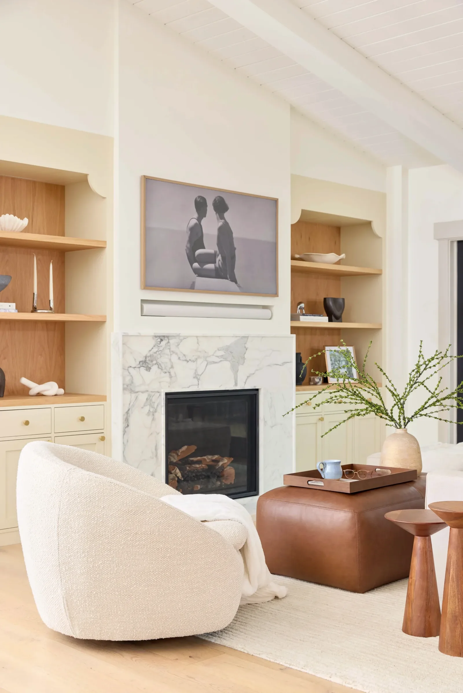 Living room with a marble fireplace surround and flanking white oak built-ins