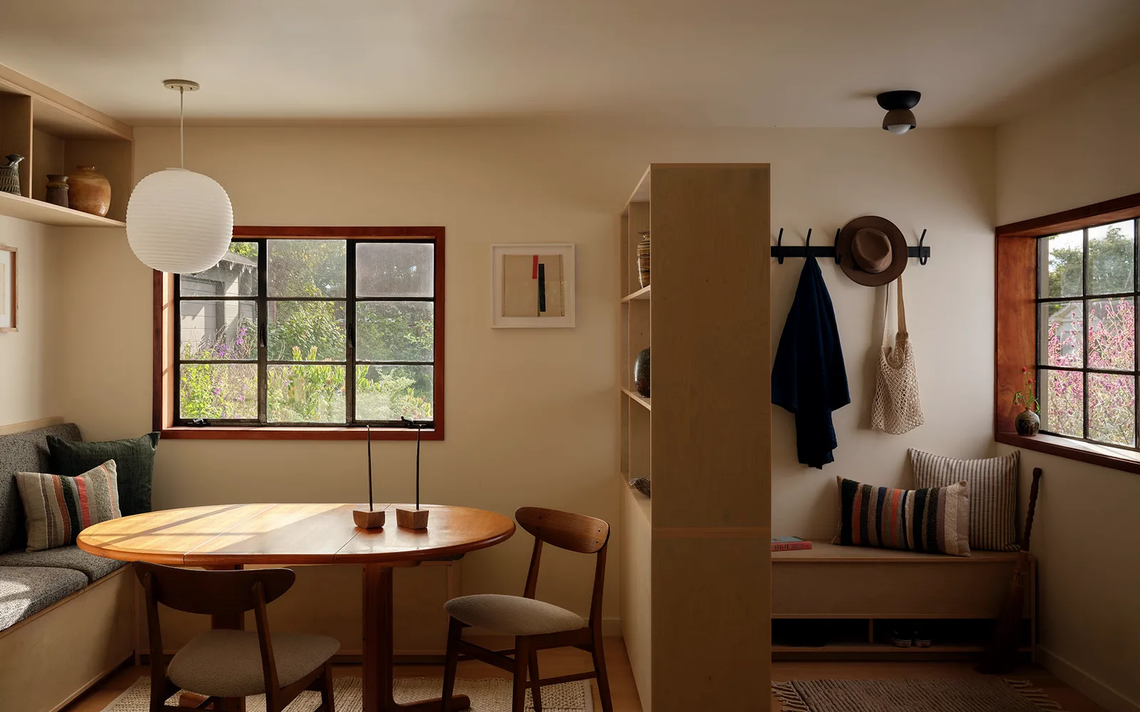 Dining nook with a round table, banquette, and window seat