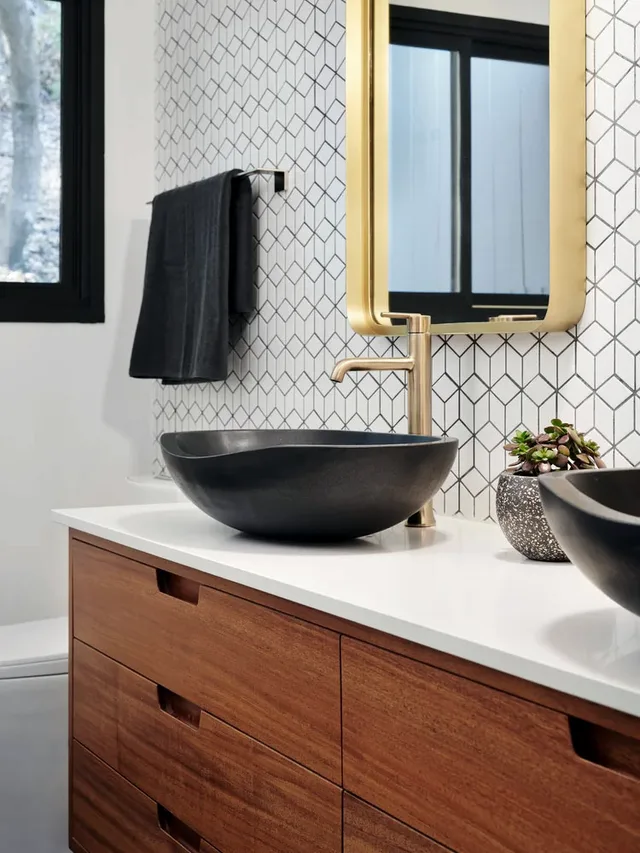 Wood vanity with a stone top and a vessel basin, close